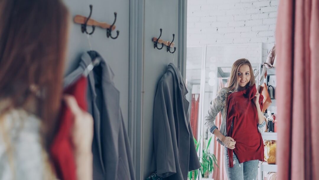 woman trying on clothes in mirror