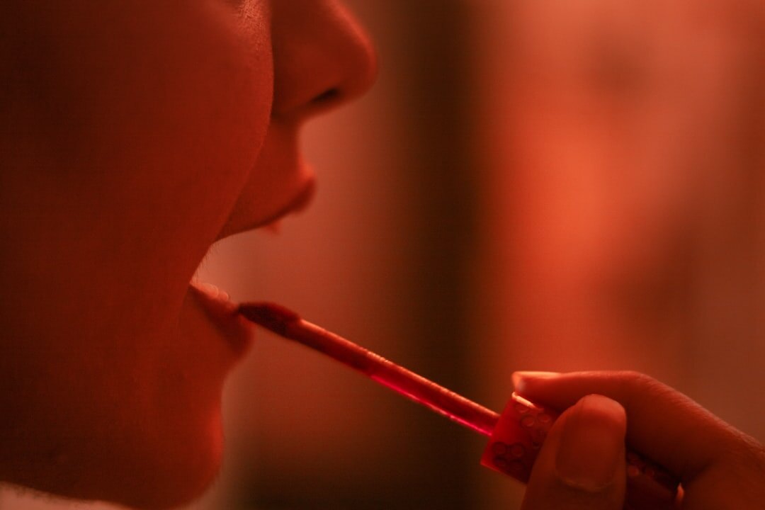 makeup artist applying lipstick