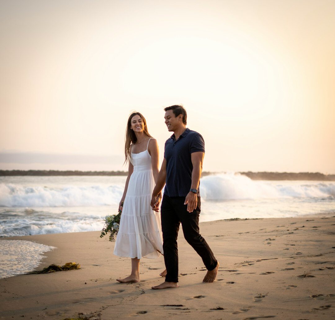 Candid paparazzi photo of a celebrity couple walking on a beach